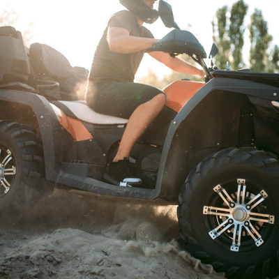Man rides fast on sandy terrain wearing gear suited for what to wear on atv tour